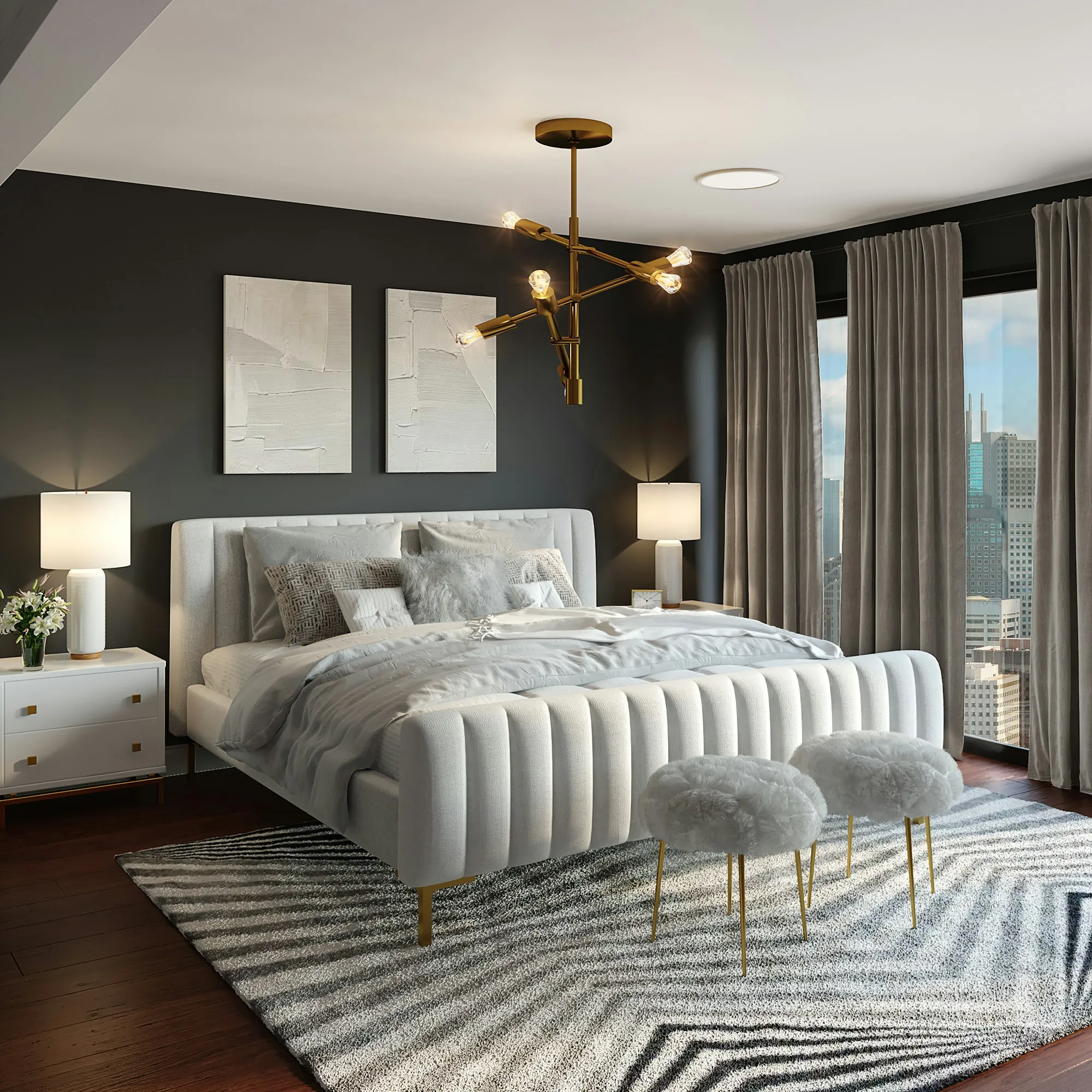 A large bedroom with a sculpted white bed and a brass chandelier